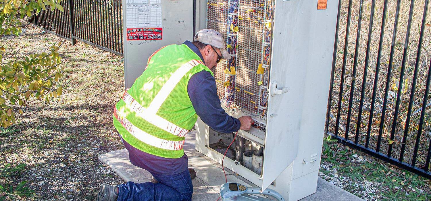 SUE crew member working on electrical box wiring system